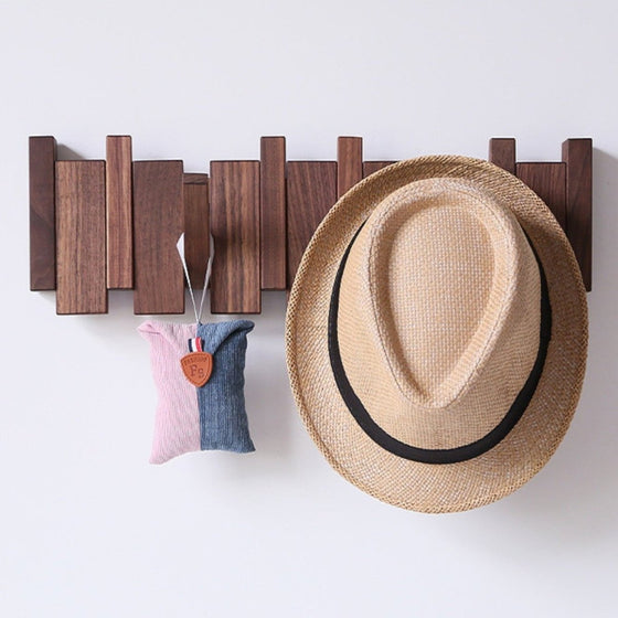 Wall mounted coat rack with folding hooks