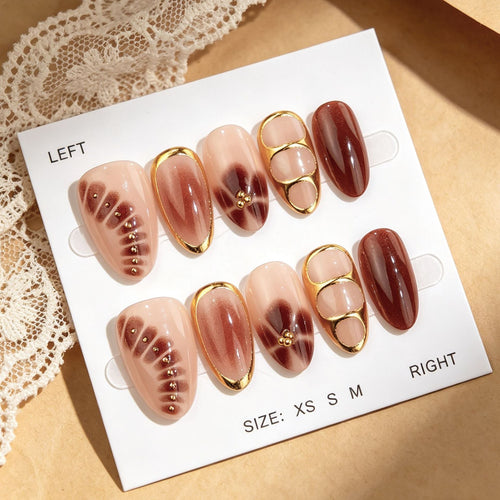 Press-on nails with rhinestones, an ombré effect, and various shapes