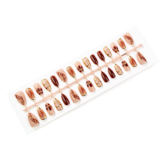 Press-on nails with rhinestones, an ombré effect, and various shapes